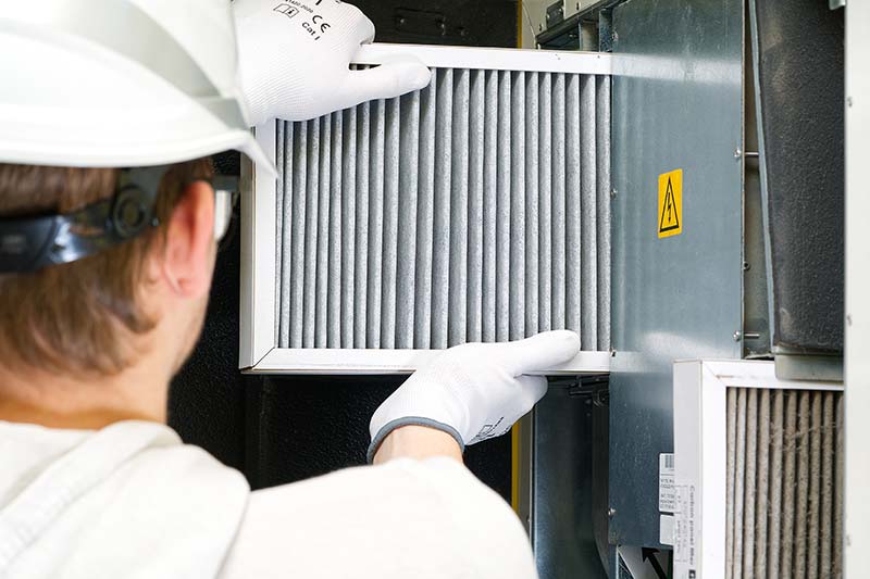 Man installing furnace filter