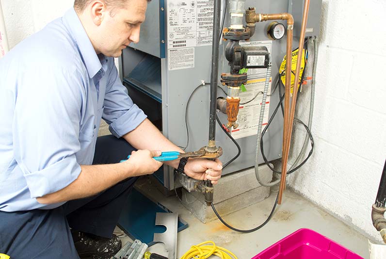 Man installing furnace gas line