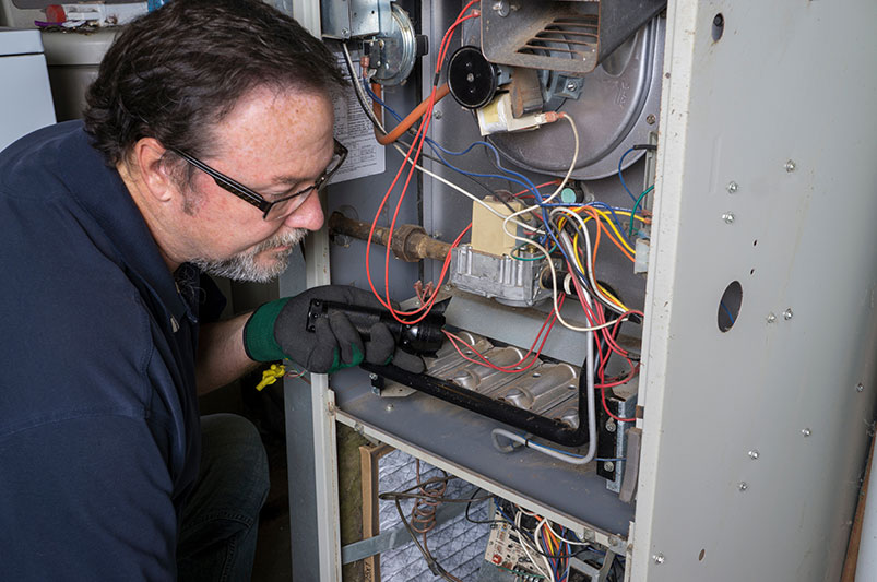 Man servicing furnace